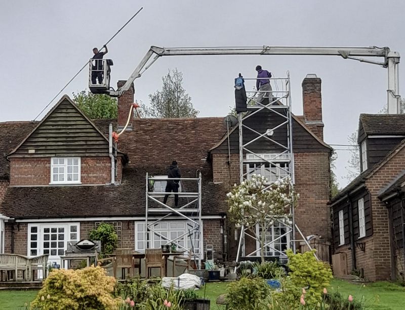 The Roof Moss Cleaners using cherry picker and scaffolding to clean roof safely and professionally in Brackley, Northamptonshire